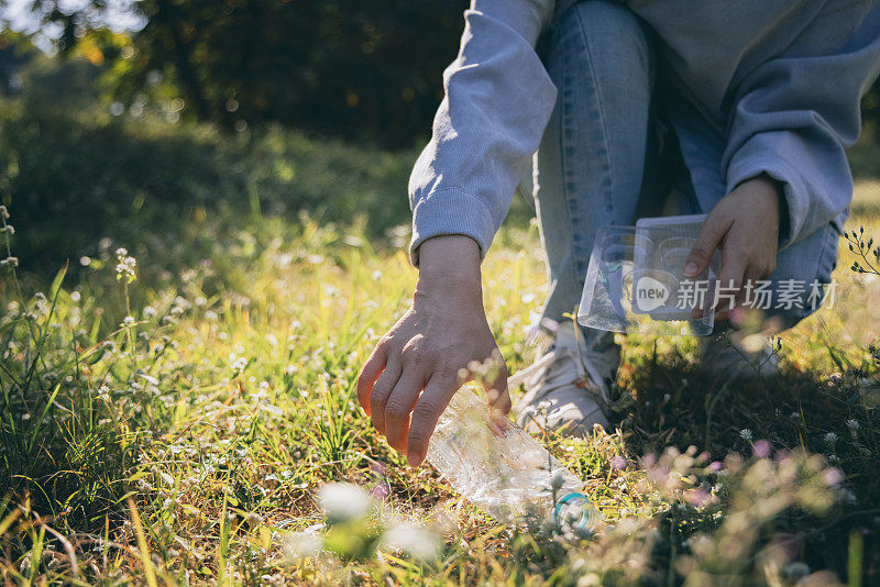 Woman hand holding garbage bottle plastic putting into recycle bag for cleaning